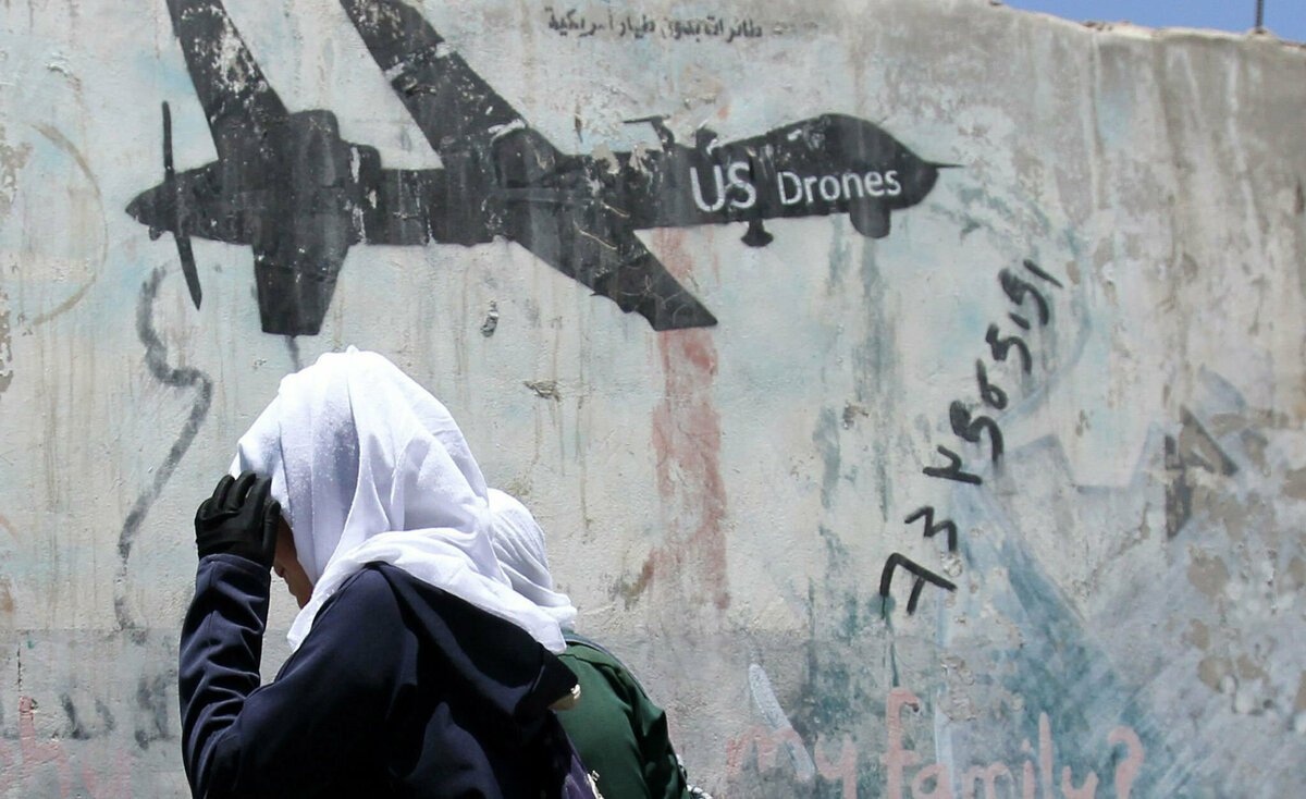 Mandatory Credit: Photo by YAHYA ARHAB/EPA-EFE/REX/Shutterstock (10184967a) Yemeni female students walk past graffiti protesting US drone airstrikes in war-affected Yemen, at a street in Sana'a, Yemen, 02 April 2019. According to reports, the United States has carried out six airstrikes against alleged targets of the local affiliate of Al-Qaeda in the Arabian Peninsula (AQAP) in central Yemen over the past three months, including the New Year?s Day airstrike that killed Jamal al-Badawi, the mastermind of the October 2000 terrorist attack against the US USS Cole warship. US airstrikes target local al-Qaeda affiliate in Yemen, Sana'a - 02 Apr 2019